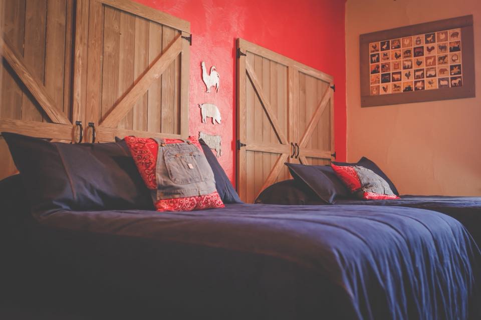 Our Barn Room has 2 Double Beds with handmade barn door headboards.  This room does not have a bathroom in the room, but a full bathroom with a shower is located just down the hall.